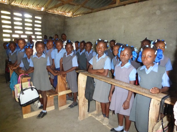 Rising to their feet, the whole class says "Good morning" in unison!