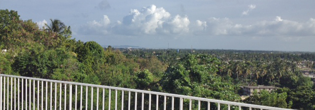 The roof has a wide view of the city of Les Cayes, the ocean and the island of Ile Vache beyond. 