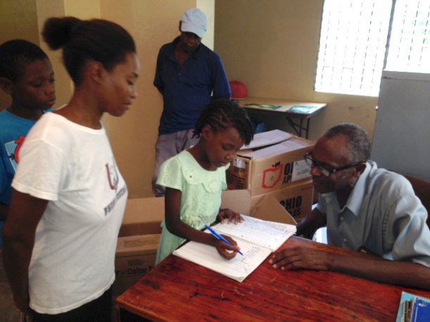 The child records their name to receive their kits.