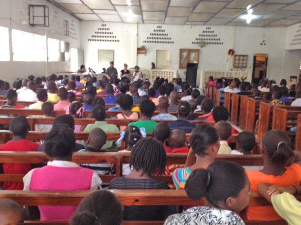 A view from the back of the meeting of us trying to share with the use of a translator.