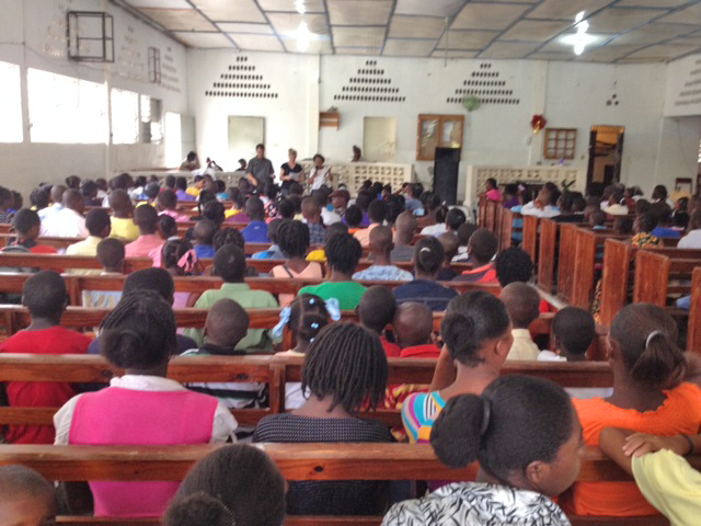 A view from the back of the meeting of us trying to share with the use of a translator.