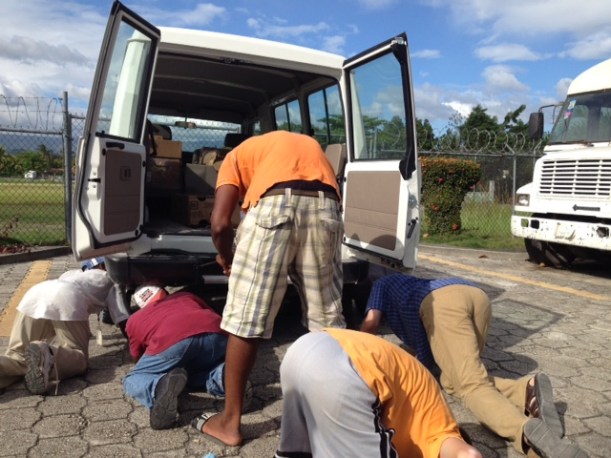 Here is a great shot of us changing my first flat tire! We are all trying to figure out how to get the spare down from underneath!