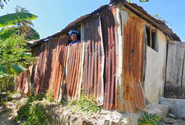 A curious child adds to the tension of this dilapidated mountain school photo.