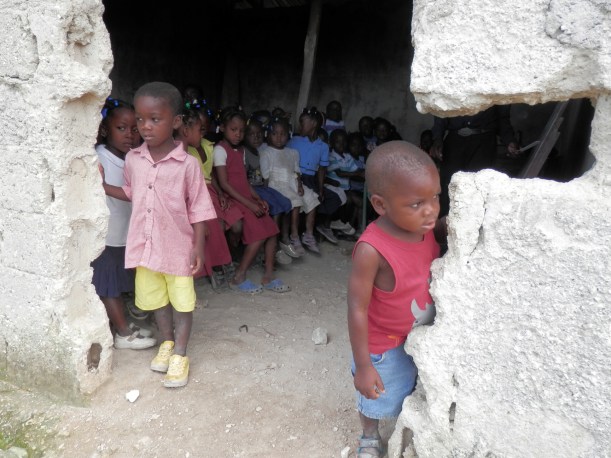 Although the desks are slim, the students are thankful for a school to attend.